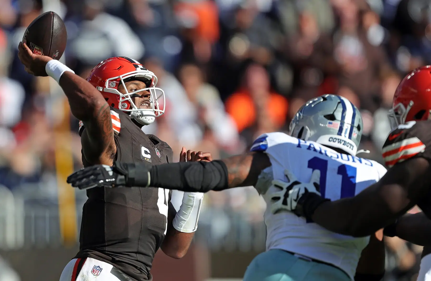 Browns QB Deshaun Watson throws as Dallas Cowboys linebacker Micah Parsons closes in during the first half, Sunday, Sept. 8, 2024, in Cleveland.