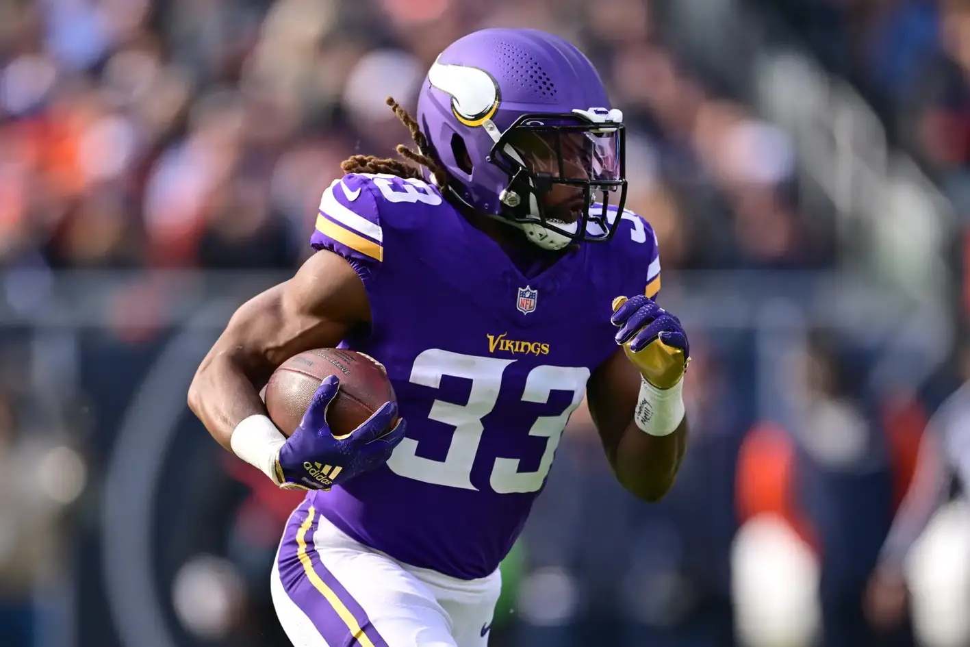 Nov 24, 2024; Chicago, Illinois, USA; Minnesota Vikings running back Aaron Jones (33) runs the ball against the Chicago Bears during the first quarter at Soldier Field. Mandatory Credit: Daniel Bartel-Imagn Images