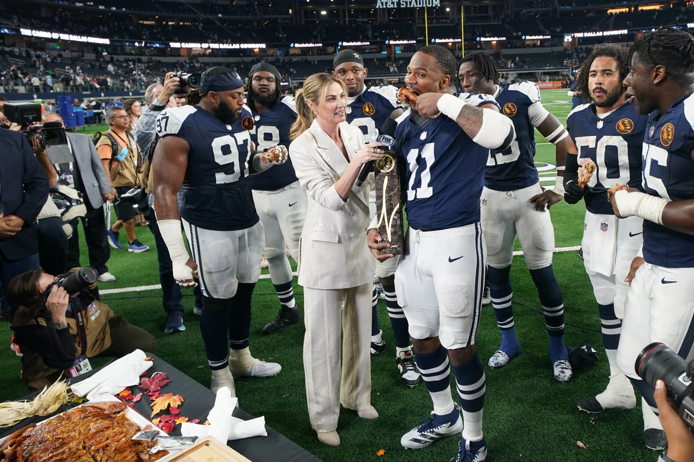 Nov 28, 2024; Arlington, Texas, USA; Dallas Cowboys linebacker Micah Parsons (11) stands with Madden Thanksgiving MVP trophy after defeating the New York Giants at AT&T Stadium. Mandatory Credit: Chris Jones-Imagn Images