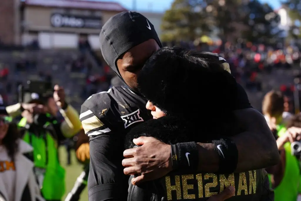 Nov 29, 2024; Boulder, Colorado, USA; Colorado Buffaloes wide receiver Travis Hunter (12) hugs his girl friend following the win against the Oklahoma State Cowboys at Folsom Field. Mandatory Credit: Ron Chenoy-Imagn Images