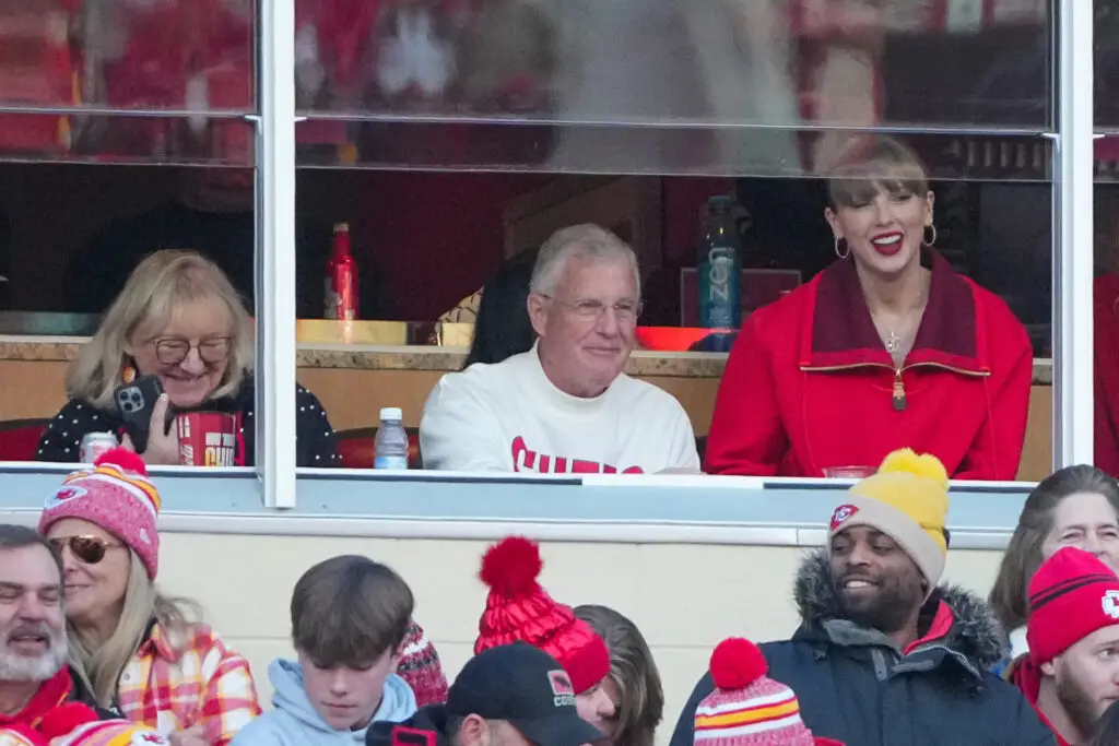 Nov 29, 2024; Kansas City, Missouri, USA; Donna Kelce and Scott Swift and pop star Taylor Swift watch play during the second half of the game between the Kansas City Chiefs and Las Vegas Raiders at GEHA Field at Arrowhead Stadium. Mandatory Credit: Denny Medley-Imagn Images