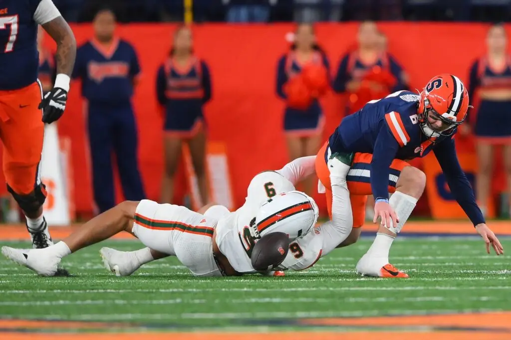 Syracuse Orange quarterback Kyle McCord (6) fumbles the ball against Miami Hurricanes defensive lineman Tyler Baron (9)