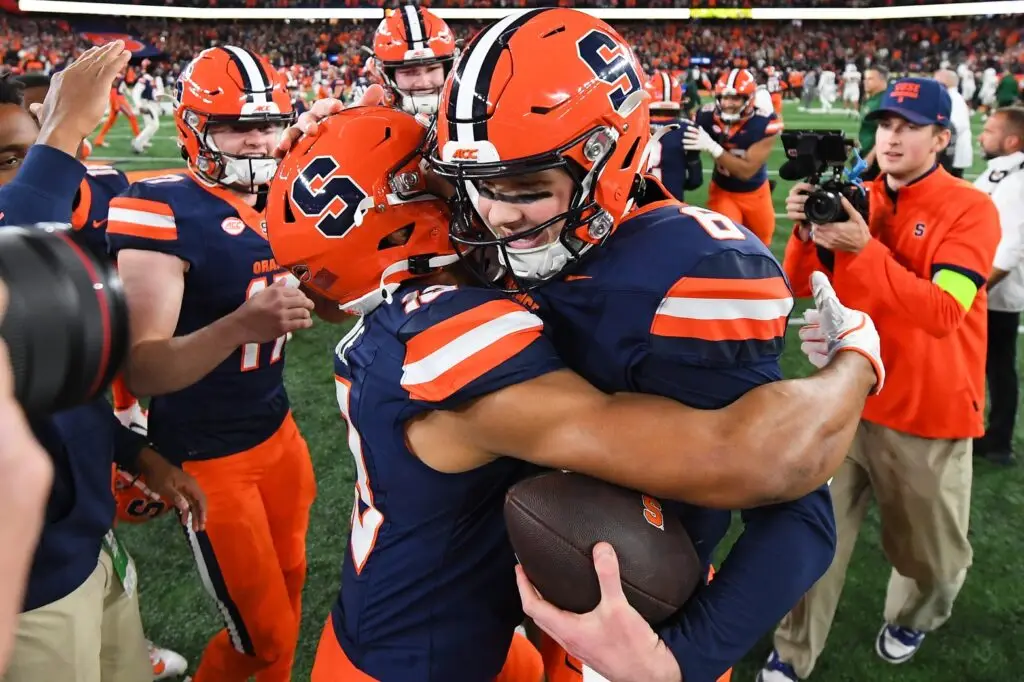 Syracuse Orange quarterback Kyle McCord (right) celebrates with tight end Jamie Tremble (left)