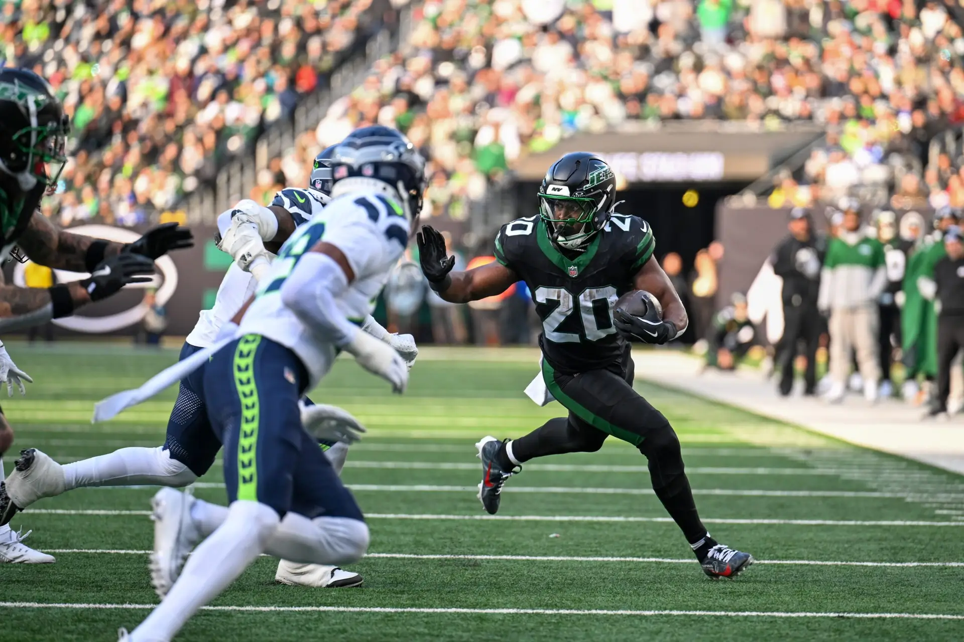 Dec 1, 2024; East Rutherford, New Jersey, USA; New York Jets running back Breece Hall (20) runs with the ball during the second quarter against the Seattle Seahawks at MetLife Stadium. Mandatory Credit: Mark Smith-Imagn Images