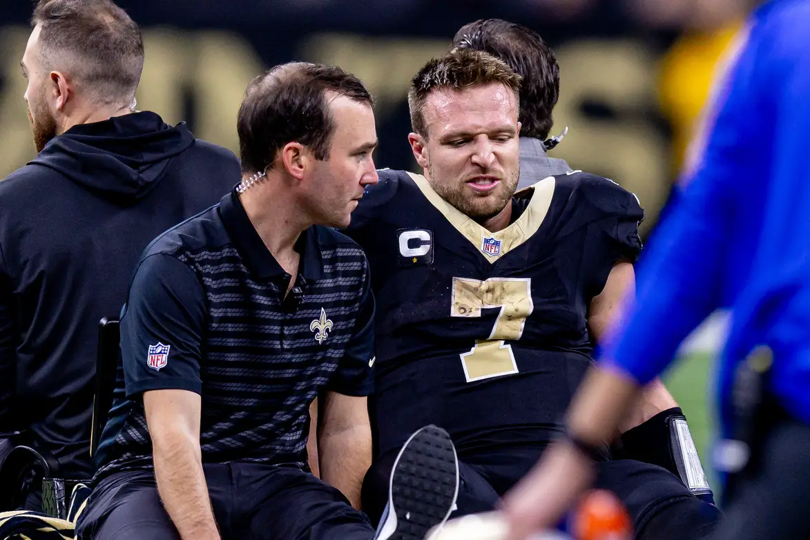 Dec 1, 2024; New Orleans, Louisiana, USA; New Orleans Saints tight end Taysom Hill (7) is injured after a tackle by Los Angeles Rams cornerback Cobie Durant (14) and has to be carted off the field during the second half at Caesars Superdome. Mandatory Credit: Stephen Lew-Imagn Images