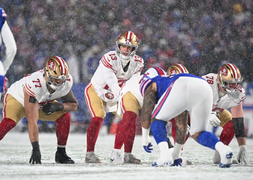 Dec 1, 2024; Orchard Park, New York, USA; San Francisco 49ers quarterback Brock Purdy (13) at the line of scrimmage against the Buffalo Bills in the first quarter at Highmark Stadium. Mandatory Credit: Mark Konezny-Imagn Images