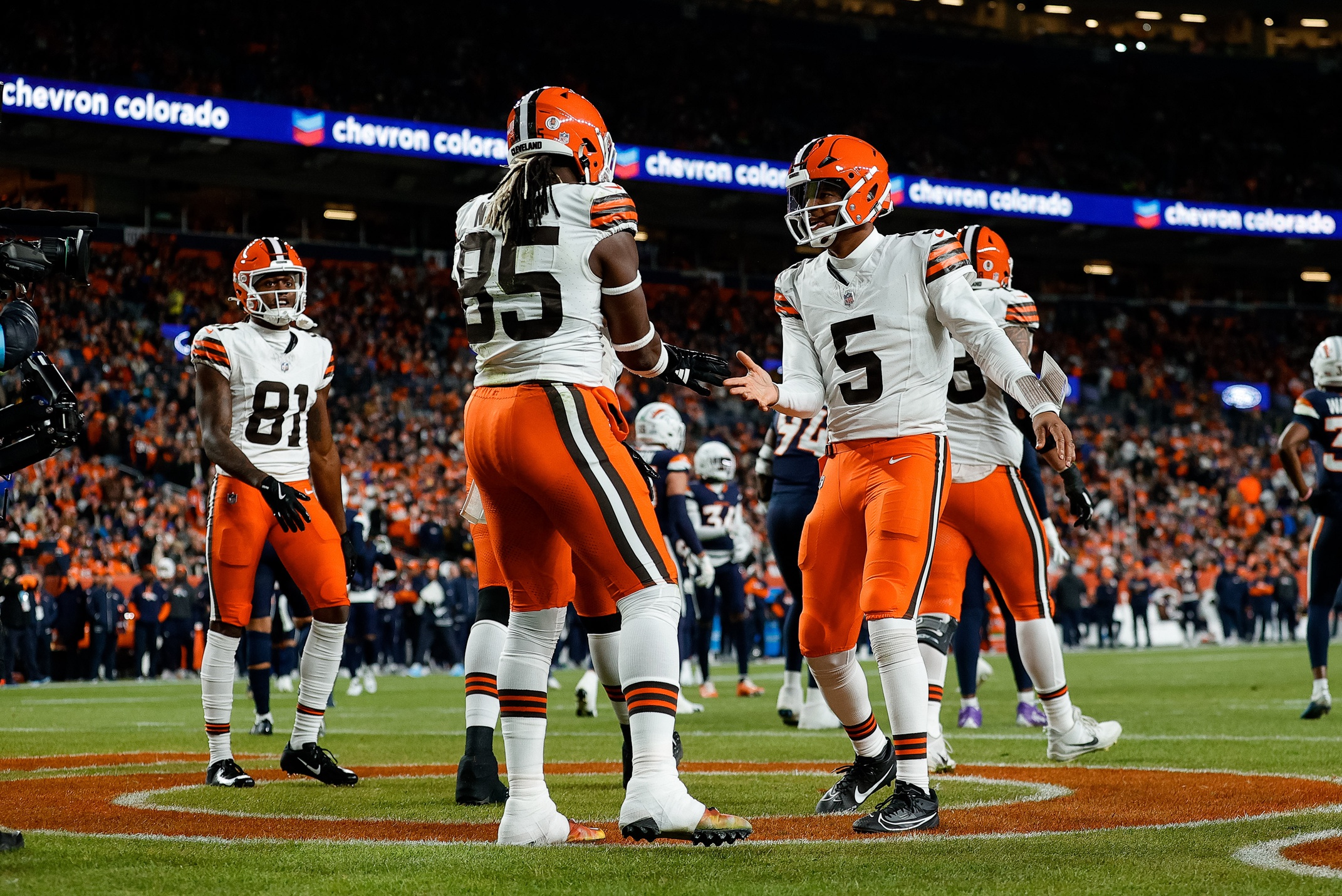 Dec 2, 2024; Denver, Colorado, USA; Cleveland Browns quarterback Jameis Winston (5) celebrates the touchdown of tight end David Njoku (85) in the first quarter against the Denver Broncos at Empower Field at Mile High. Mandatory Credit: Isaiah J. Downing-Imagn Images