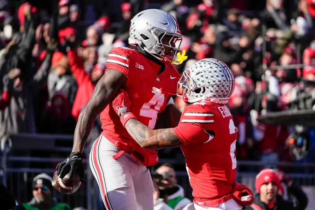Ohio State Buckeyes wide receiver Emeka Egbuka (2) celebrates a touchdown by wide receiver Jeremiah Smith (4) during the NCAA football game against the Michigan Wolverines
