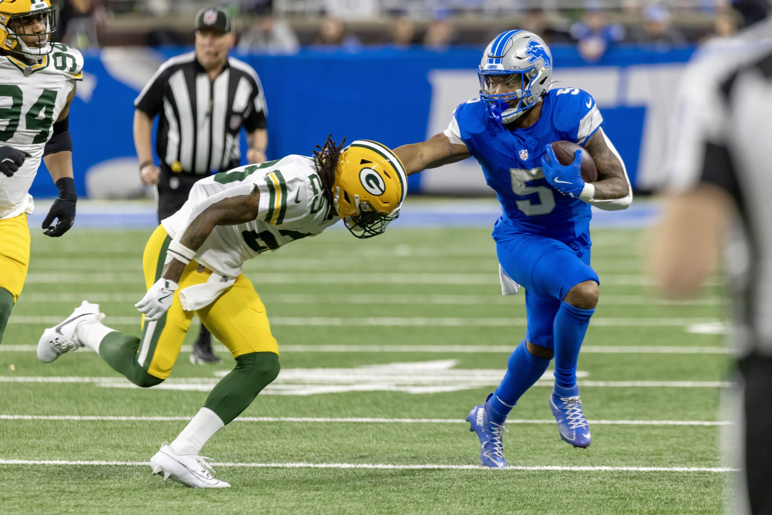 Dec 5, 2024; Detroit, Michigan, USA; Detroit Lions running back David Montgomery (5) runs with the ball and is pushed out of bounds by Green Bay Packers safety Xavier McKinney (29) during the first half at Ford Field. Mandatory Credit: David Reginek-Imagn Images