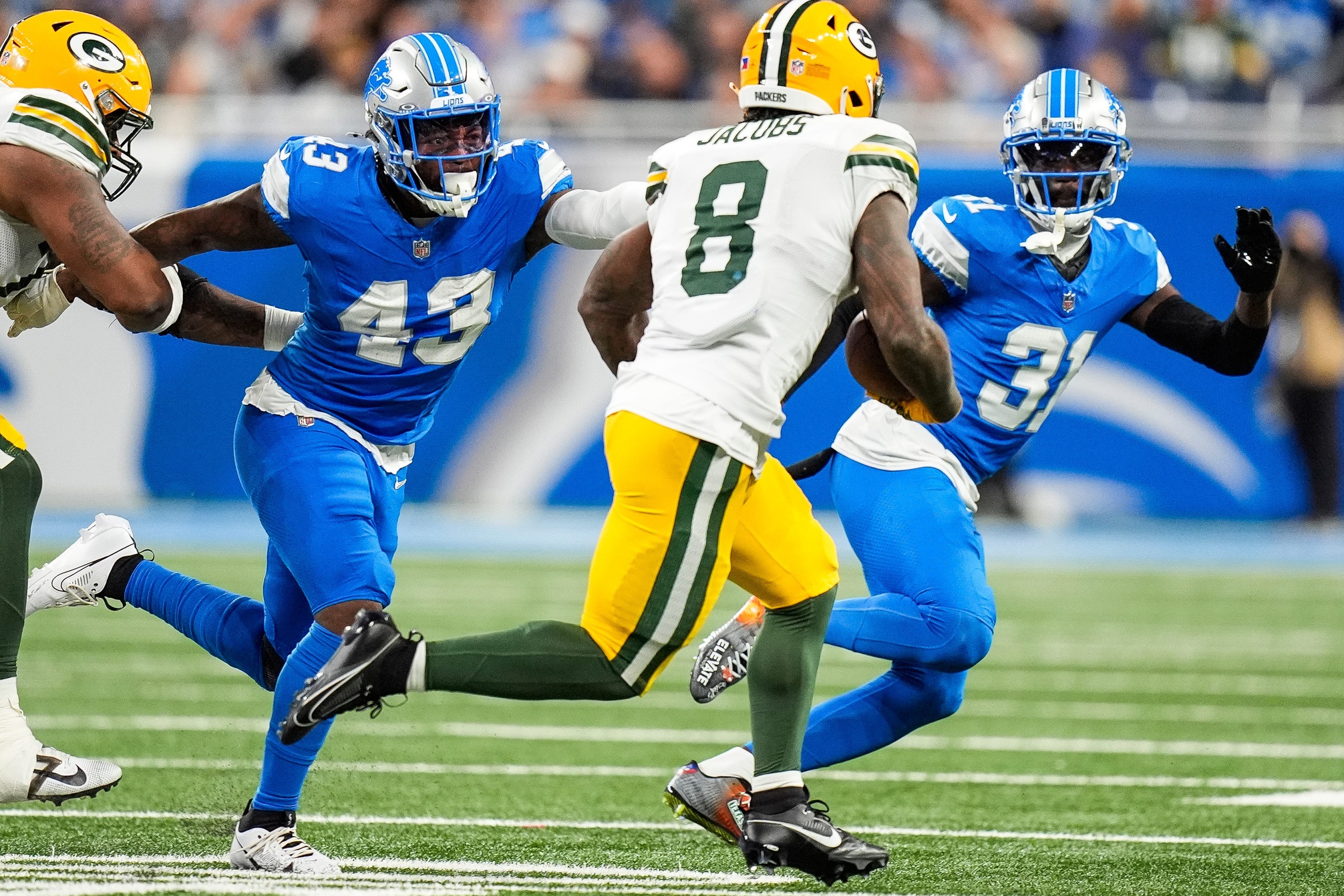 Detroit Lions linebacker David Long Jr. (43) and safety Kerby Joseph (31) defend Green Bay Packers running back Josh Jacobs (8) during the first half at Ford Field in Detroit on Thursday, Dec. 5, 2024. © Junfu Han / USA TODAY NETWORK via Imagn Images