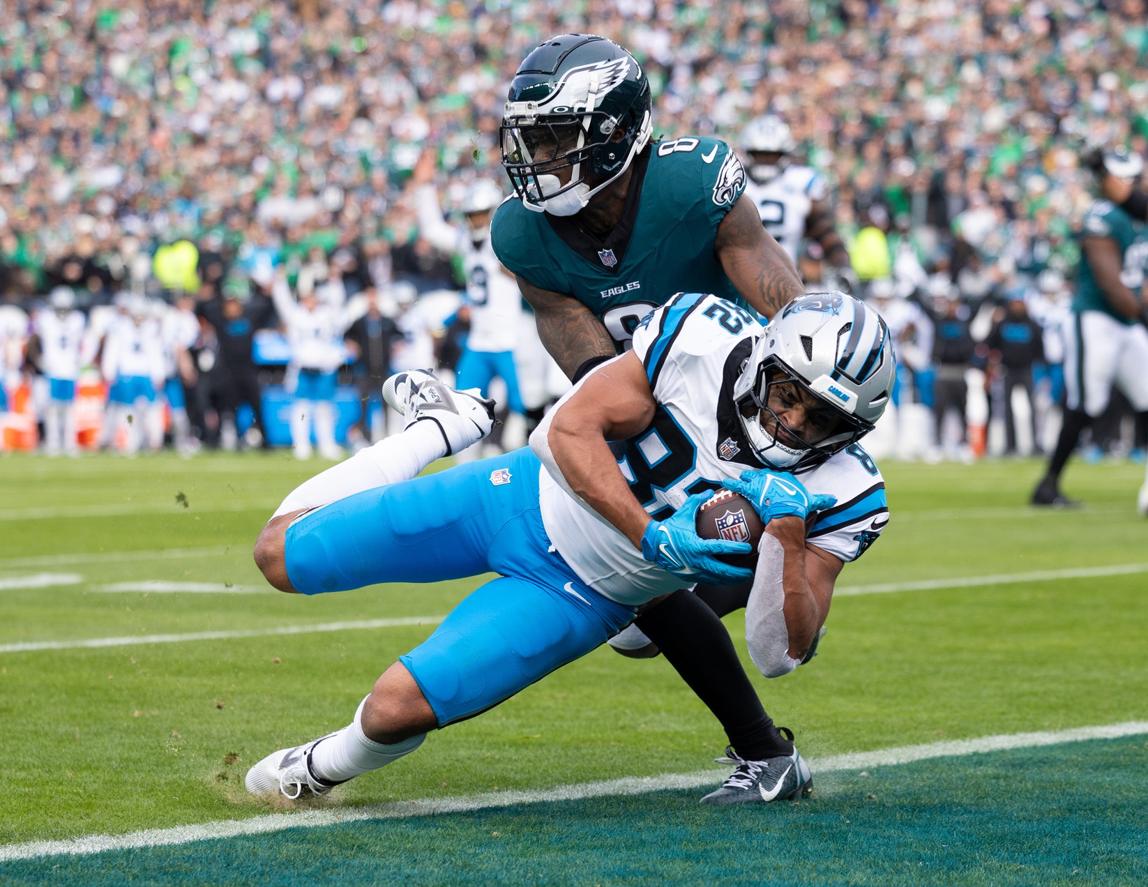 Dec 8, 2024; Philadelphia, Pennsylvania, USA; Carolina Panthers tight end Tommy Tremble (82) scores a touchdown past Philadelphia Eagles safety C.J. Gardner-Johnson (8) during the second quarter at Lincoln Financial Field. Mandatory Credit: Bill Streicher-Imagn Images