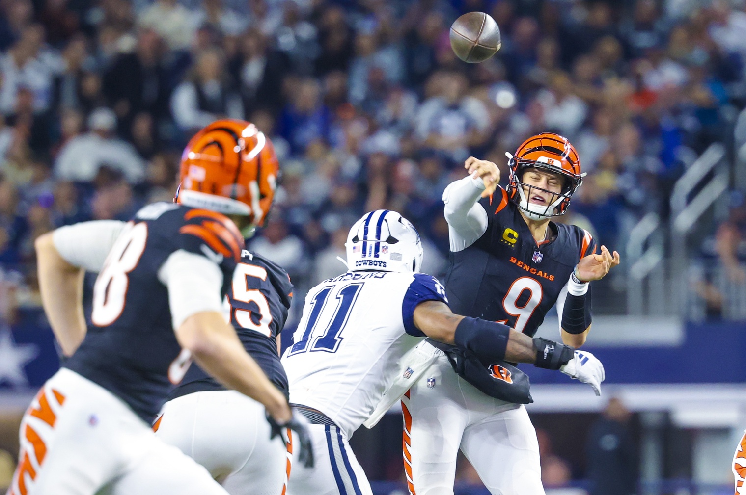 Dec 9, 2024; Arlington, Texas, USA; Cincinnati Bengals quarterback Joe Burrow (9) throws as Dallas Cowboys linebacker Micah Parsons (11) defends during the second half at AT&T Stadium. Mandatory Credit: Kevin Jairaj-Imagn Images