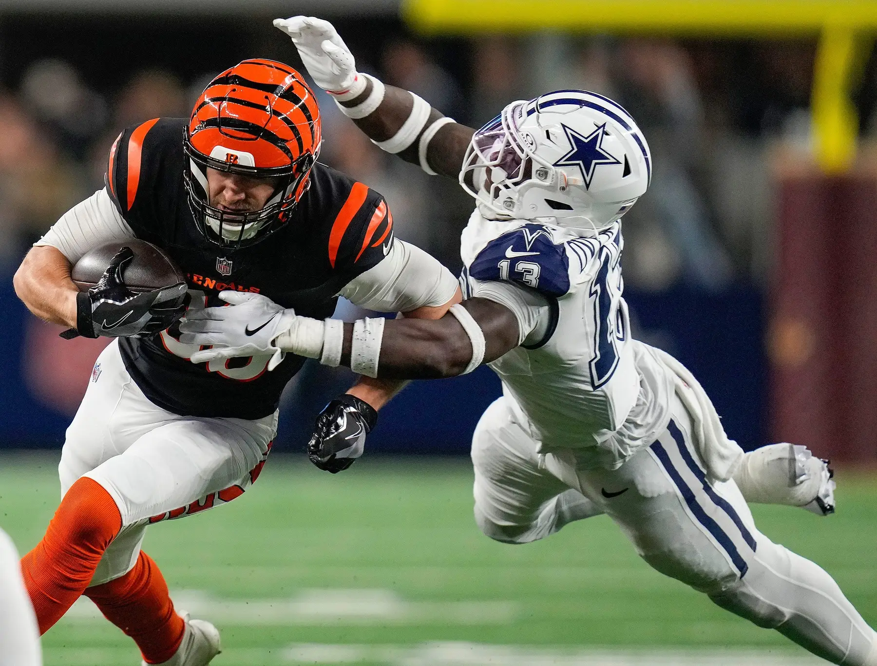 Cincinnati Bengals tight end Mike Gesicki (88) tries to break free from Dallas Cowboys linebacker DeMarvion Overshown (13) during the first half Monday Night Football at AT&T Stadium in Arlington,Texas on Monday, December 9, 2024. © Cara Owsley/The Enquirer / USA TODAY NETWORK via Imagn Images