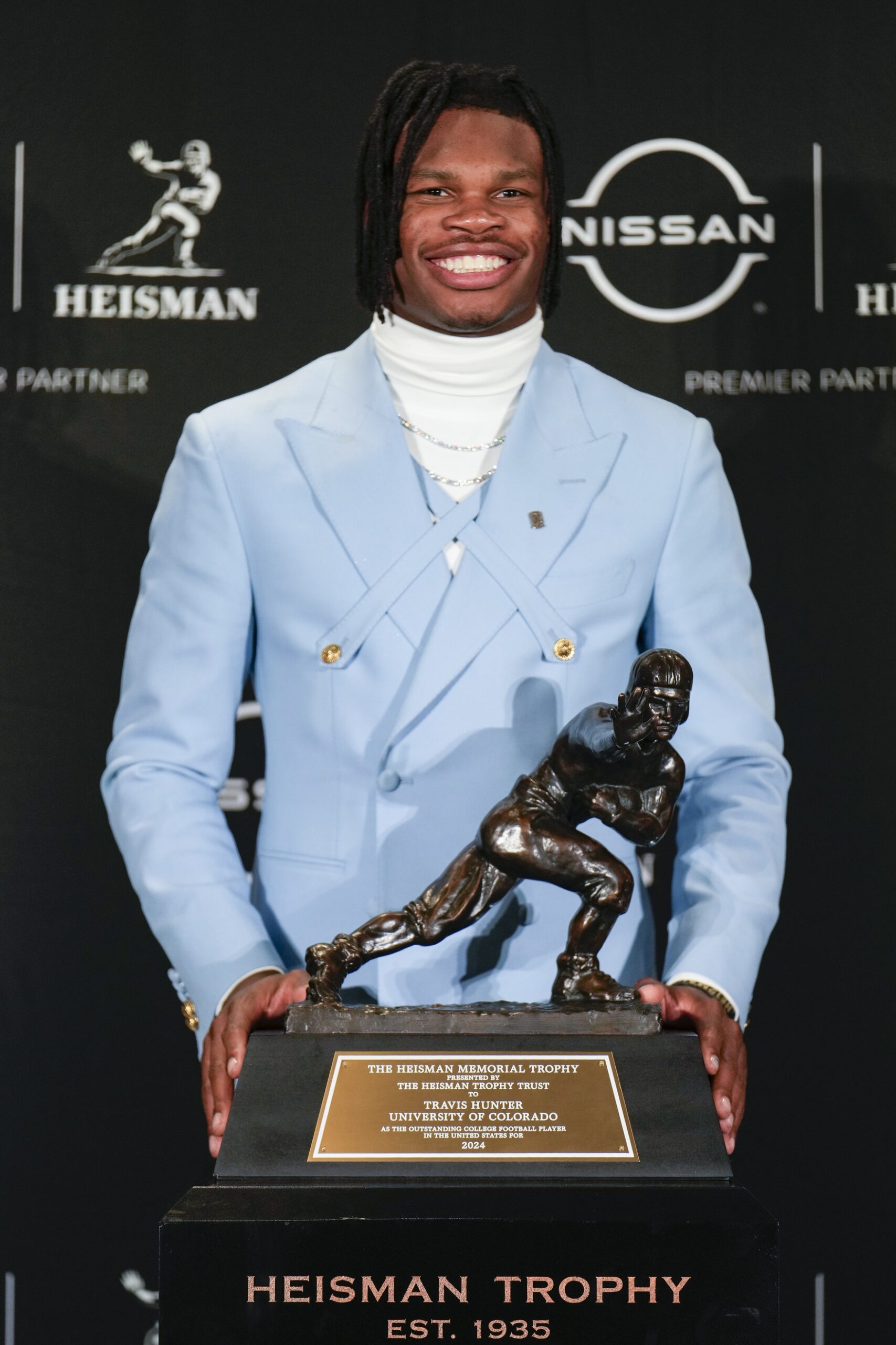 Dec 14, 2024; New York, NY, USA; Colorado Buffaloes wide receiver/cornerback Travis Hunter poses for a photo after winning the Heisman Trophy award during the 2024 Heisman Trophy Presentation. Mandatory Credit: Lucas Boland-Imagn Images