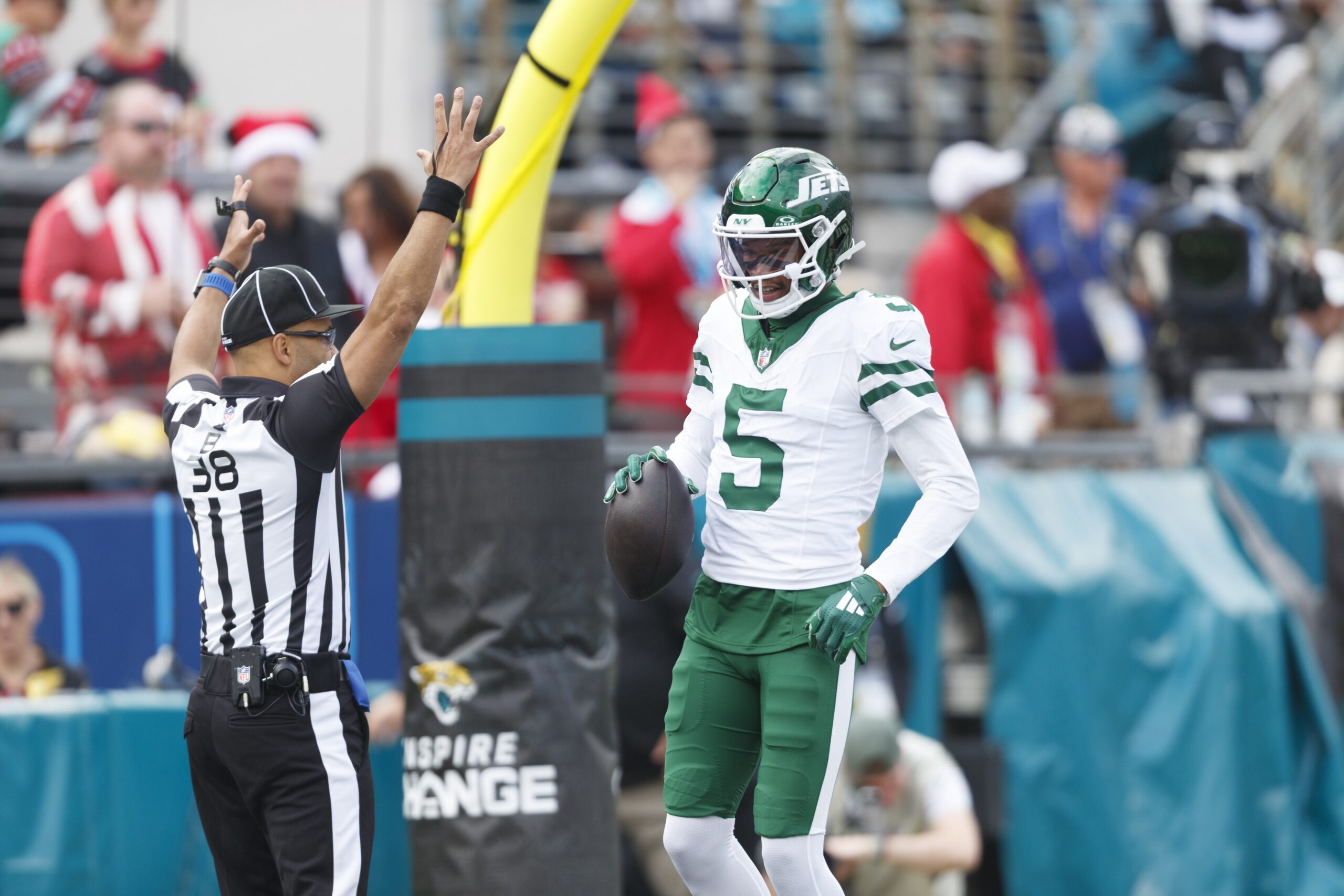 Dec 15, 2024; Jacksonville, Florida, USA; New York Jets wide receiver Garrett Wilson (5) celebrates a touchdown against the Jacksonville Jaguars during the first quarter at EverBank Stadium. Mandatory Credit: Morgan Tencza-Imagn Images