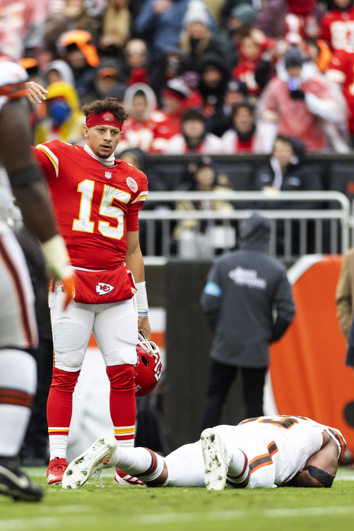 Dec 15, 2024; Cleveland, Ohio, USA; Kansas City Chiefs quarterback Patrick Mahomes (15) calls for medical attention to Cleveland Browns defensive end Myles Garrett (95) during the second quarter at Huntington Bank Field. Mandatory Credit: Scott Galvin-Imagn Images