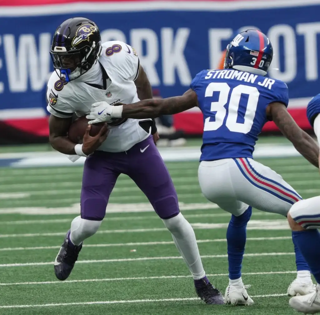 Lamar Jackson of the Ravens and Greg Stroman Jr. of the Giants