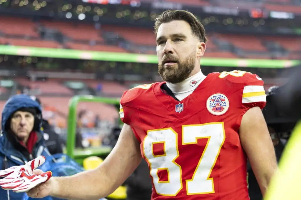 Dec 15, 2024; Cleveland, Ohio, USA; Kansas City Chiefs tight end Travis Kelce (87) gives his gloves to a fan following a game against the Cleveland Browns at Huntington Bank Field. Mandatory Credit: Scott Galvin-Imagn Images