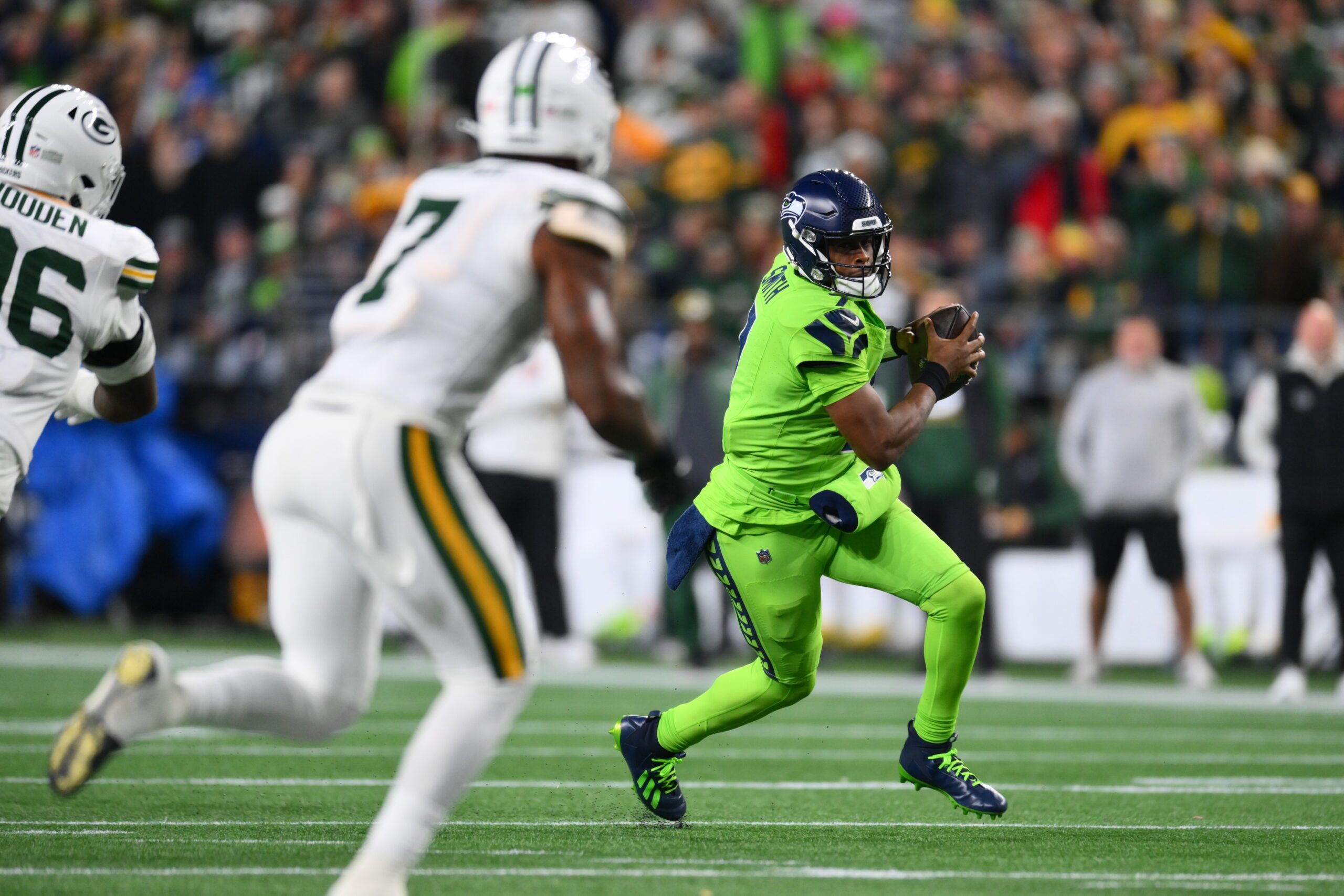 Dec 15, 2024; Seattle, Washington, USA; Seattle Seahawks quarterback Geno Smith (7) carries the ball against the Green Bay Packers during the first half at Lumen Field. Mandatory Credit: Steven Bisig-Imagn Images