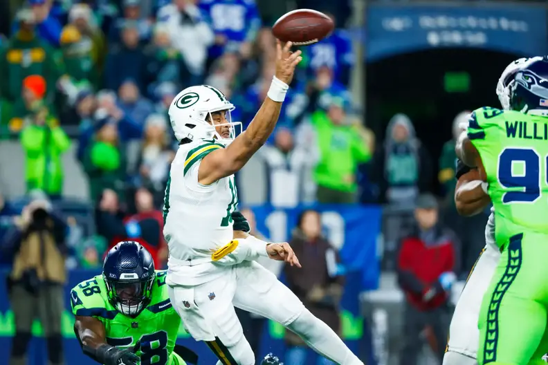 Dec 15, 2024; Seattle, Washington, USA; Green Bay Packers quarterback Jordan Love (10) passes while under pressure from Seattle Seahawks linebacker Derick Hall (58) during the second quarter at Lumen Field. Mandatory Credit: Joe Nicholson-Imagn Images