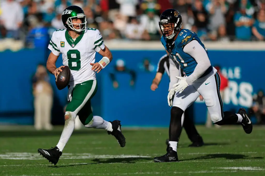 New York Jets quarterback Aaron Rodgers (8) is pressured by Jacksonville Jaguars defensive end Arik Armstead (91) during the fourth quarter Sunday, Dec. 15, 2024 at EverBank Stadium in Jacksonville, Fla. The Jets held off the Jaguars 32-25. [Corey Perrine/Florida Times-Union]