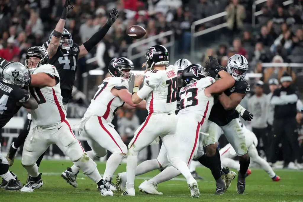 Dec 16, 2024; Paradise, Nevada, USA; Atlanta Falcons quarterback Kirk Cousins (18) throws the ball against Las Vegas Raiders linebacker Robert Spillane (41) in the second half at Allegiant Stadium. Mandatory Credit: Kirby Lee-Imagn Images