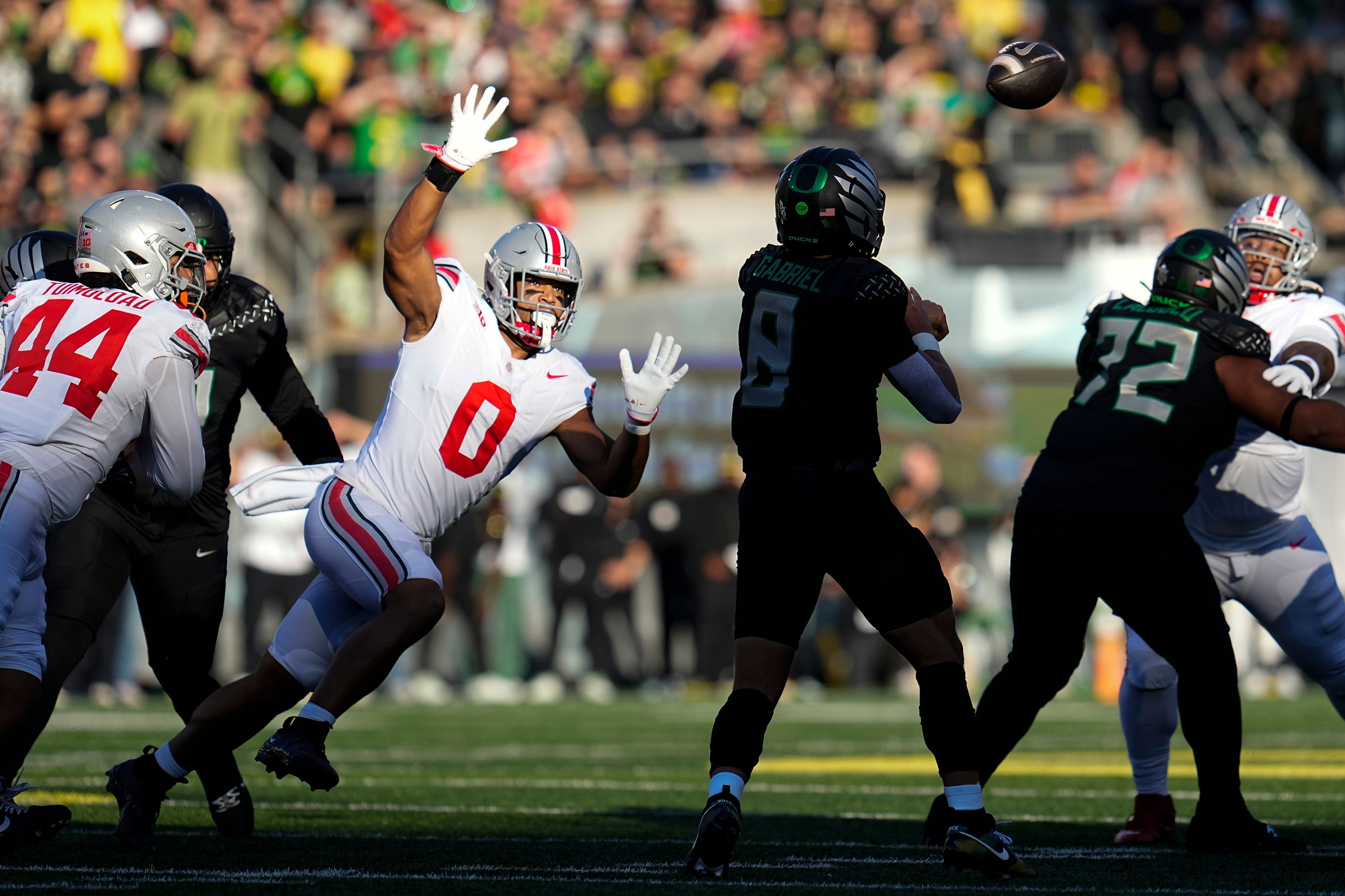 Oct 12, 2024; Eugene, Oregon, USA; Ohio State Buckeyes linebacker Cody Simon (0) pressures Oregon Ducks quarterback Dillon Gabriel (8) during the first half of the NCAA football game at Autzen Stadium © Adam Cairns/Columbus Dispatch / USA TODAY NETWORK via Imagn Images