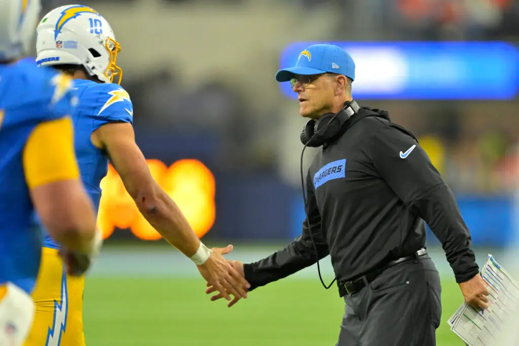 Dec 19, 2024; Inglewood, California, USA; Los Angeles Chargers head coach Jim Harbaugh congratulates quarterback Justin Herbert (10) after a touchdown in the second half against the Denver Broncos at SoFi Stadium. Mandatory Credit: Jayne Kamin-Oncea-Imagn Images