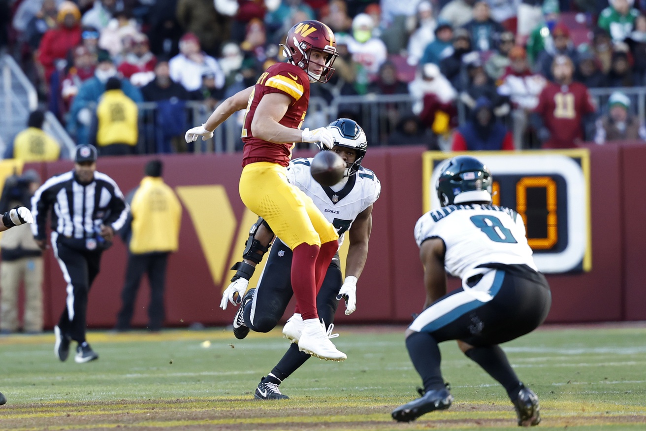 Dec 22, 2024; Landover, Maryland, USA; Washington Commanders wide receiver Luke McCaffrey (12) watches as an intended pass intercepted by Philadelphia Eagles safety C.J. Gardner-Johnson (8) during the second quarter at Northwest Stadium. Mandatory Credit: Geoff Burke-Imagn Images