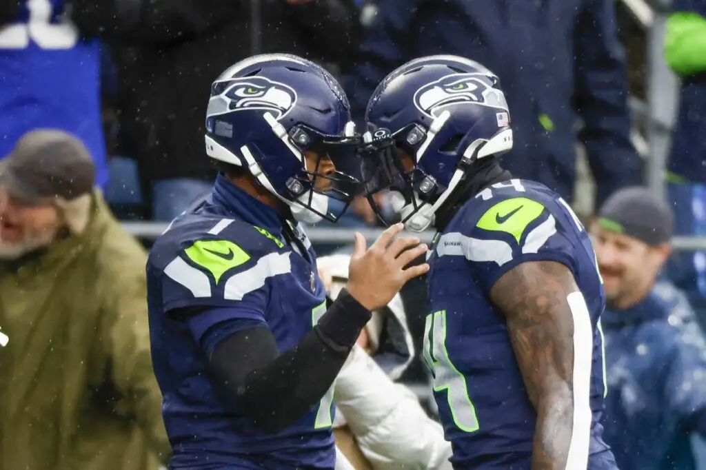 Dec 22, 2024; Seattle, Washington, USA; Seattle Seahawks quarterback Geno Smith (7) celebrates with Seattle Seahawks wide receiver DK Metcalf (14) following a touchdown pass to Metcalf during the second quarter against the Minnesota Vikings at Lumen Field. Mandatory Credit: Joe Nicholson-Imagn Images. Seattle