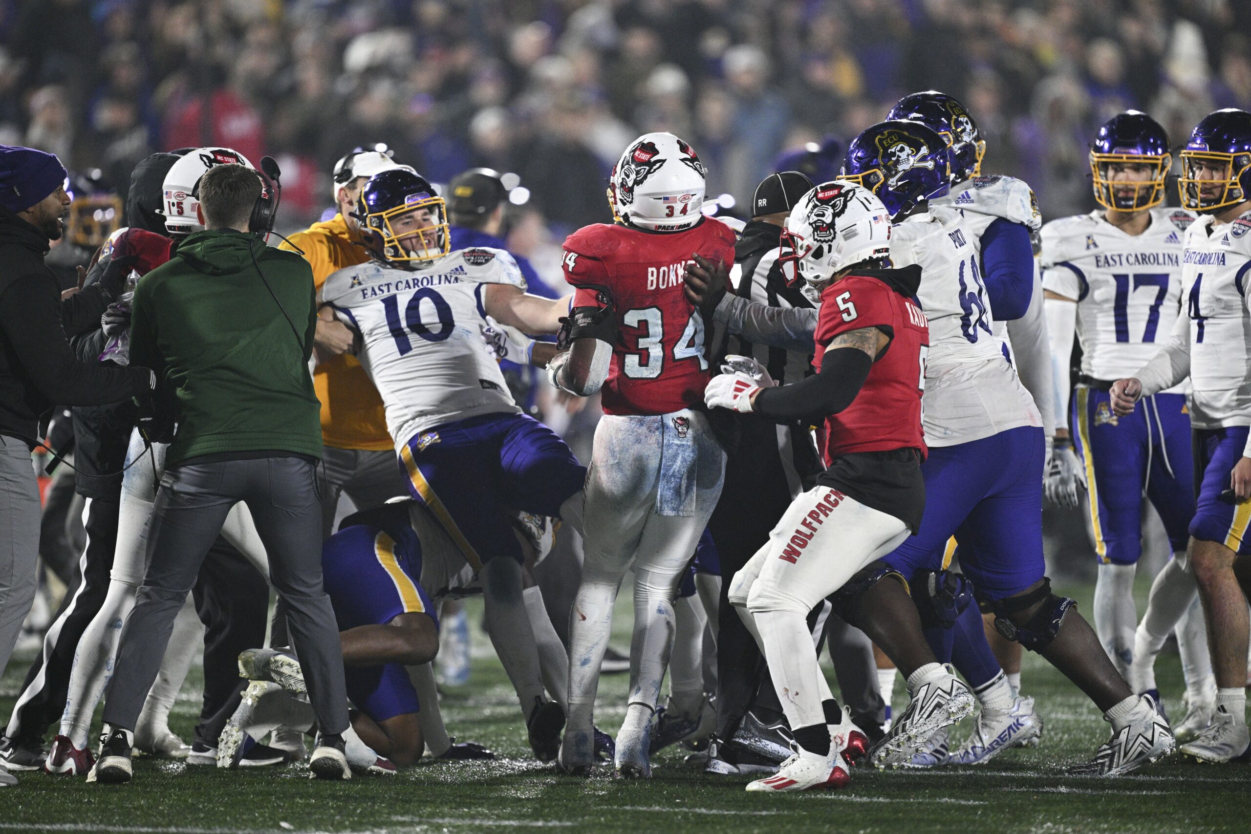 Dec 28, 2024; Annapolis, MD, USA; North Carolina State Wolfpack and East Carolina Pirates players fight during the second half of the Go Bowling Military Bowl at Navy-Marine Corps Memorial Stadium. Mandatory Credit: Tommy Gilligan-Imagn Images college football