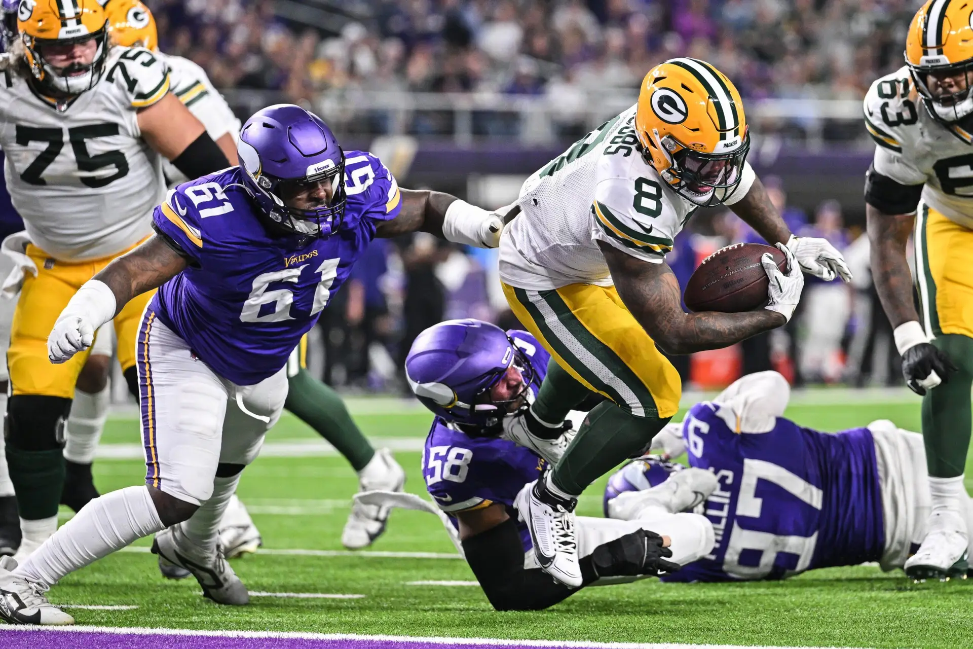 Dec 29, 2024; Minneapolis, Minnesota, USA; Green Bay Packers running back Josh Jacobs (8) runs for a touchdown as Minnesota Vikings defensive tackle Jalen Redmond (61) chases during the third quarter at U.S. Bank Stadium. Mandatory Credit: Jeffrey Becker-Imagn Images