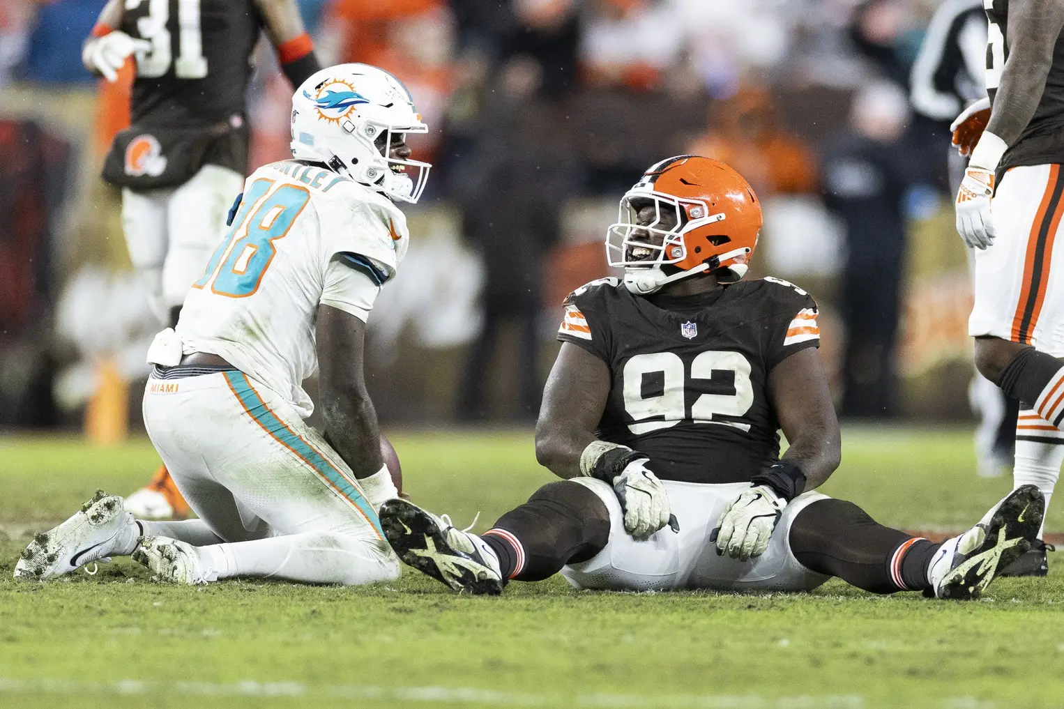 Breaking: Shedeur Sanders Injury Forces Browns To Sign 25-Game NFL QB 2 Dec 29, 2024; Cleveland, Ohio, USA; Miami Dolphins quarterback Tyler Huntley (18) laughs with Cleveland Browns defensive end Sam Kamara (92) following a tackle during the fourth quarter at Huntington Bank Field. Mandatory Credit: Scott Galvin-Imagn Images