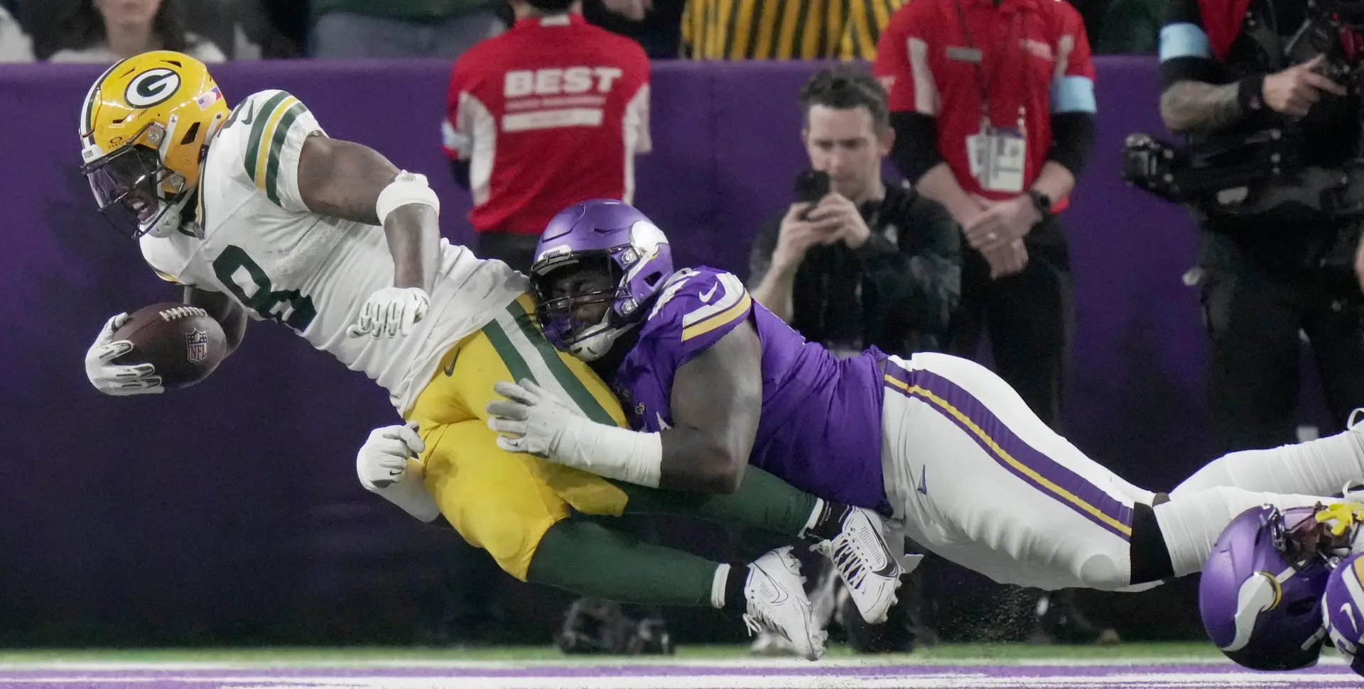 Minnesota Vikings defensive tackle Jalen Redmond (61) is unable to stop Green Bay Packers running back Josh Jacobs (8) from scoring a touchdown during the third quarter of their game Sunday, December 29, 2024 at U.S. Bank Stadium in Minneapolis, Minnesota. The Minnesota Vikings beat the Green Bay Packers 27-25. © Mark Hoffman/Milwaukee Journal Sentinel / USA TODAY NETWORK via Imagn Images