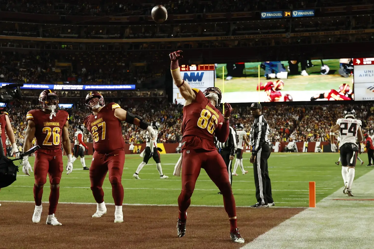 Dec 29, 2024; Landover, Maryland, USA; Washington Commanders tight end Zach Ertz (86) celebrates by throwing the ball into the stands after catching a touchdown pass against the Atlanta Falcons during the third quarter at Northwest Stadium. Mandatory Credit: Geoff Burke-Imagn Images