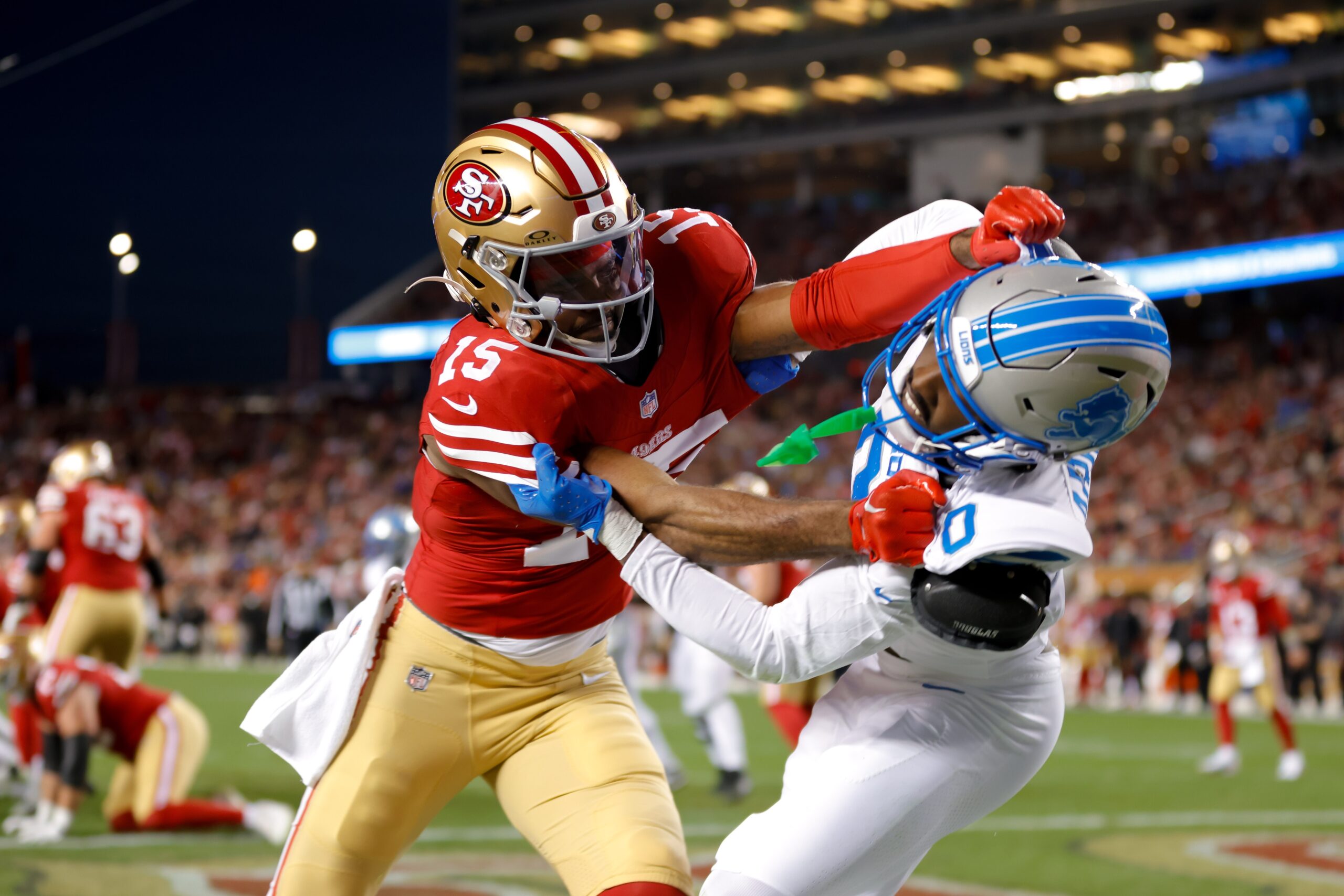 Dec 30, 2024; Santa Clara, California, USA; San Francisco 49ers wide receiver Jauan Jennings (15) and Detroit Lions cornerback Terrion Arnold (0) get tangled after a play during the first quarter at Levi's Stadium. Mandatory Credit: Sergio Estrada-Imagn Images