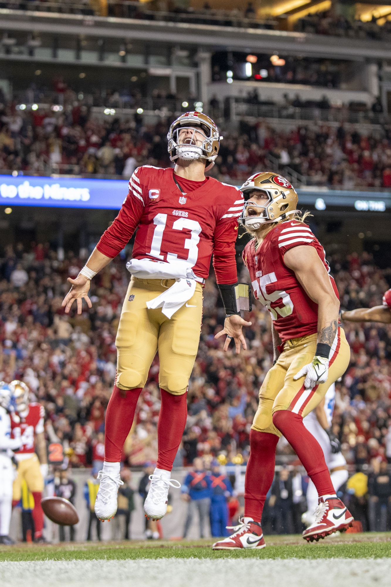 December 30, 2024; Santa Clara, California, USA; San Francisco 49ers quarterback Brock Purdy (13) celebrates with tight end George Kittle (85) after scoring a touchdown against the Detroit Lions during the second quarter at Levi's Stadium. Mandatory Credit: Kyle Terada-Imagn Images