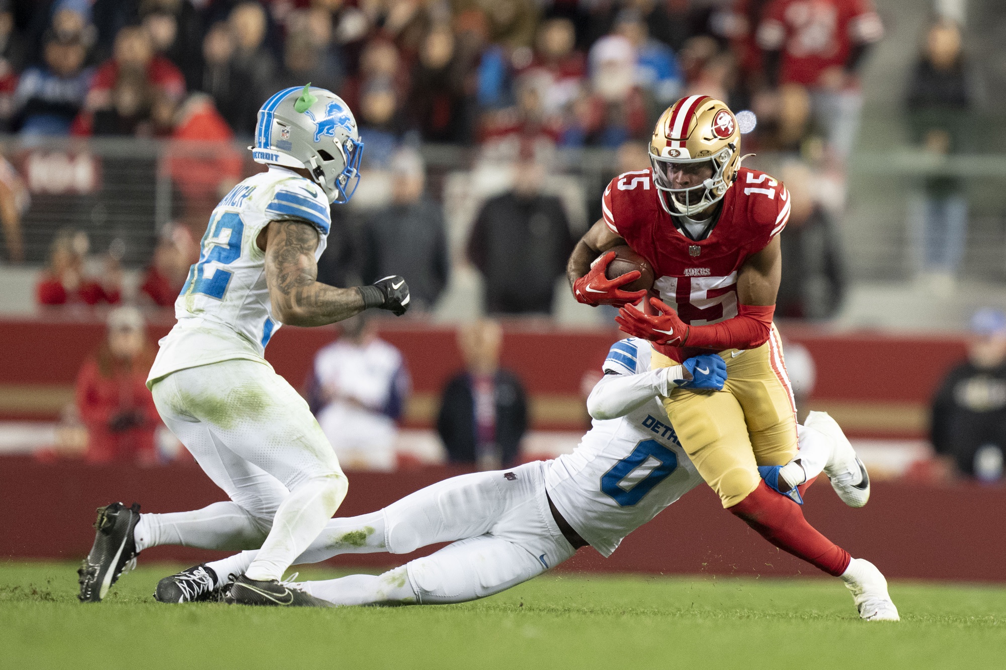 December 30, 2024; Santa Clara, California, USA; San Francisco 49ers wide receiver Jauan Jennings (15) is tackled by Detroit Lions cornerback Terrion Arnold (0) during the fourth quarter at Levi's Stadium. Mandatory Credit: Kyle Terada-Imagn Images