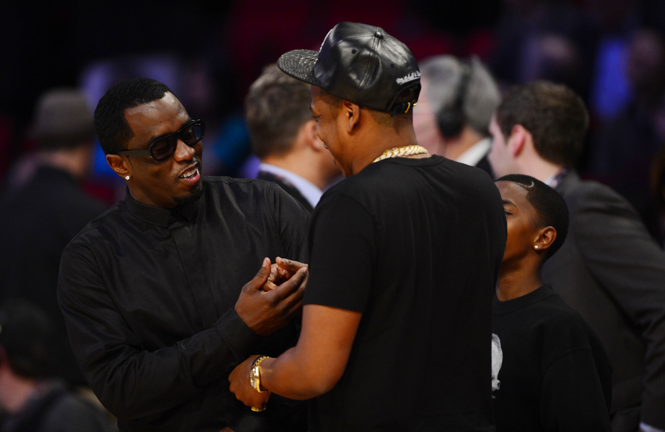 Feb 17, 2013; Houston, TX, USA; Recording artists Sean Combs (left) and Jay-Z greet each other before the 2013 NBA all star game at the Toyota Center. Mandatory Credit: Bob Donnan-Imagn Images NFL