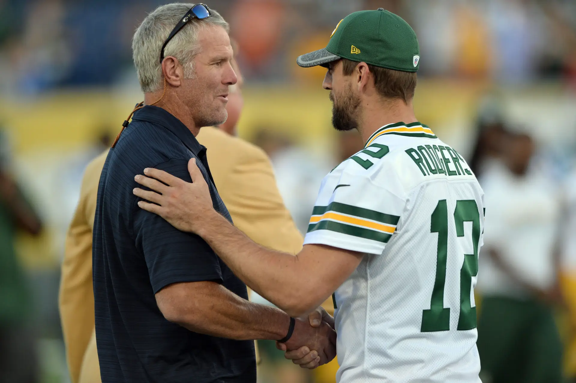 Aug 7, 2016; Canton, OH, USA; Green Bay Packers quarterback Aaron Rodgers (12) greets Hall of Fame member Brett Favre before the game between the Indianapolis Colts and the Green Bay Packers at the 2016 Hall of Fame Game at Tom Benson Hall of Fame Stadium. The game was cancelled due to safety concerns with the condition of the playing surface. Mandatory Credit: Ken Blaze-Imagn Images