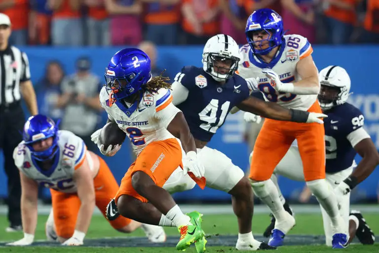 Dec 31, 2024; Glendale, AZ, USA; Boise State Broncos running back Ashton Jeanty (2) rushes the ball against the Penn State Nittany Lions during the first half in the Fiesta Bowl at State Farm Stadium. Mandatory Credit: Mark J. Rebilas-Imagn Images