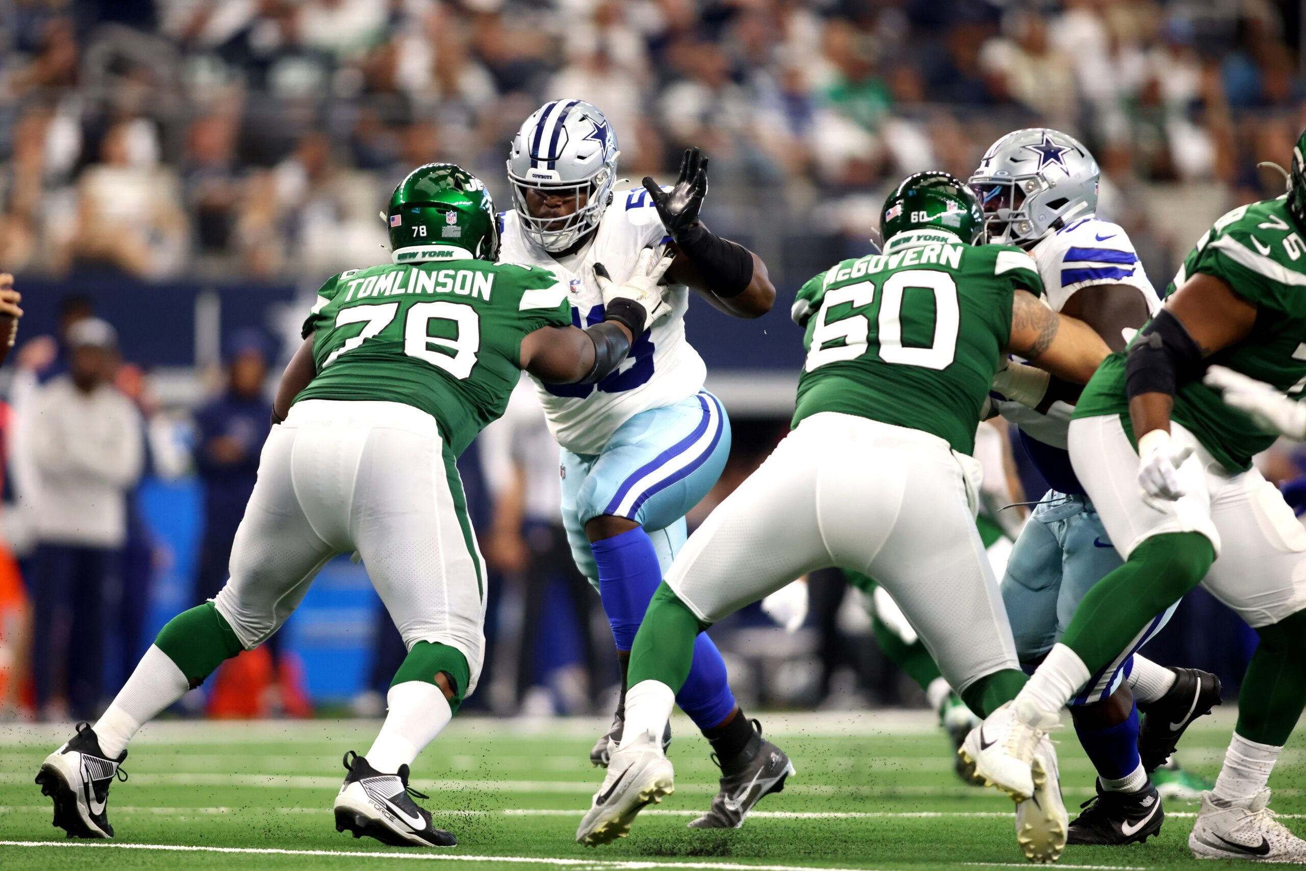 Sep 17, 2023; Arlington, Texas, USA; Dallas Cowboys defensive tackle Mazi Smith (58) rushes the passer while blocked by New York Jets guard Laken Tomlinson (78) in the third quarter at AT&T Stadium. Mandatory Credit: Tim Heitman-Imagn Images