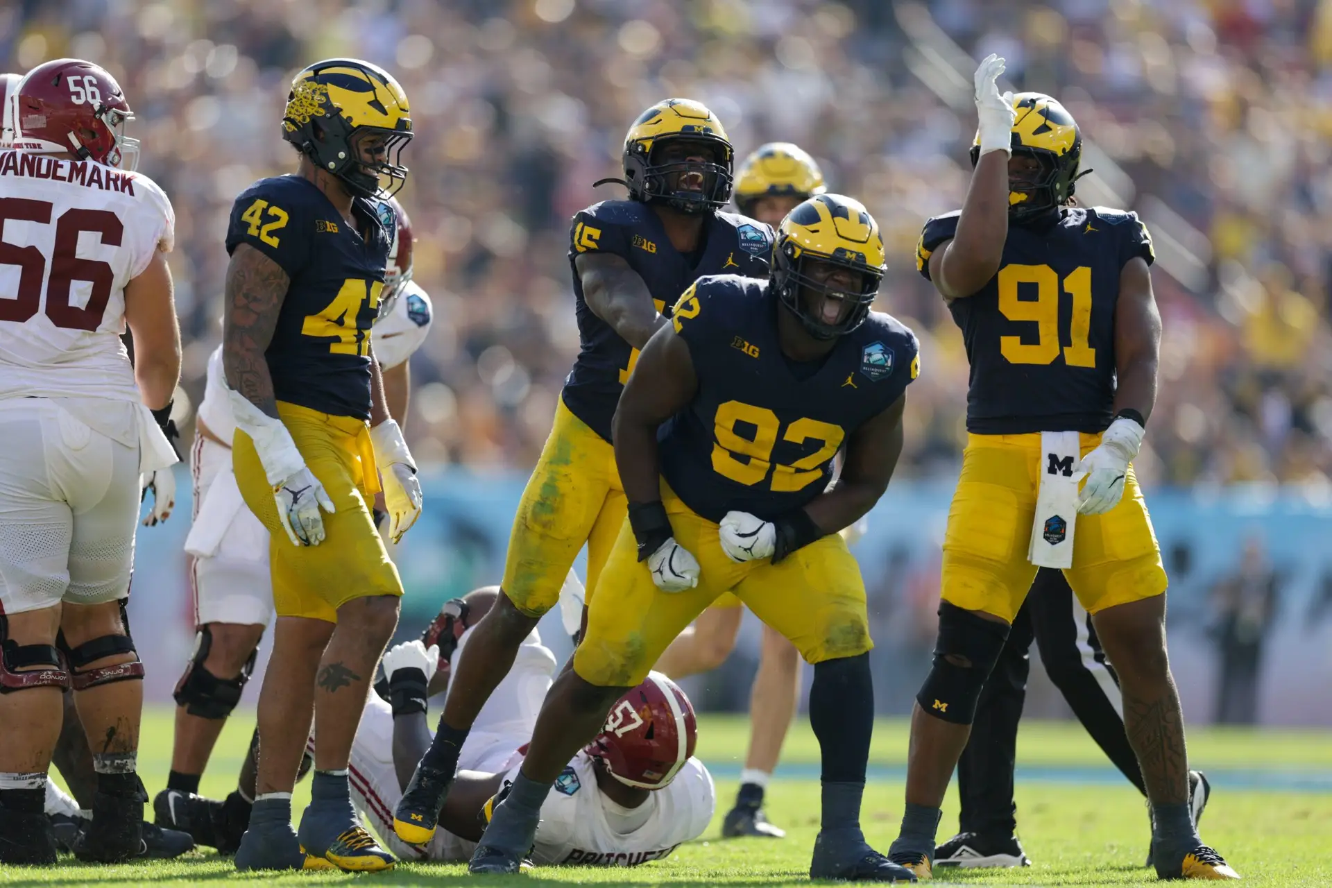 Dec 31, 2024; Tampa, FL, USA; Alabama Crimson Tide quarterback Jalen Milroe (4) is sacked by Michigan Wolverines defensive lineman Ike Iwunnah (92) in the third quarter during the ReliaQuest Bowl at Raymond James Stadium. Mandatory Credit: Nathan Ray Seebeck-Imagn Images