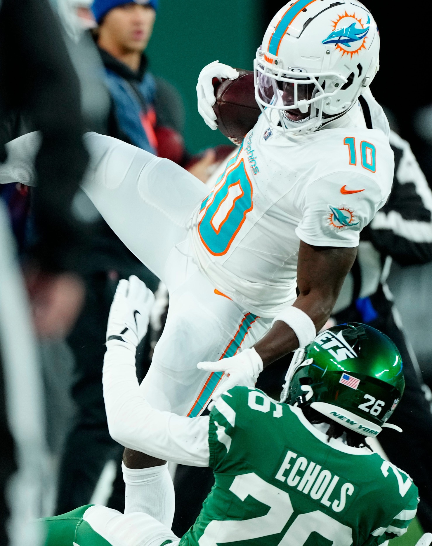 Miami Dolphins wide receiver Tyreek Hill (10) holds onto the ball as New York Jets cornerback Brandin Echols (26) takes him down, Sunday January 5, 2025, in East Rutherford. © Kevin R. Wexler-NorthJersey.com / USA TODAY NETWORK via Imagn Images