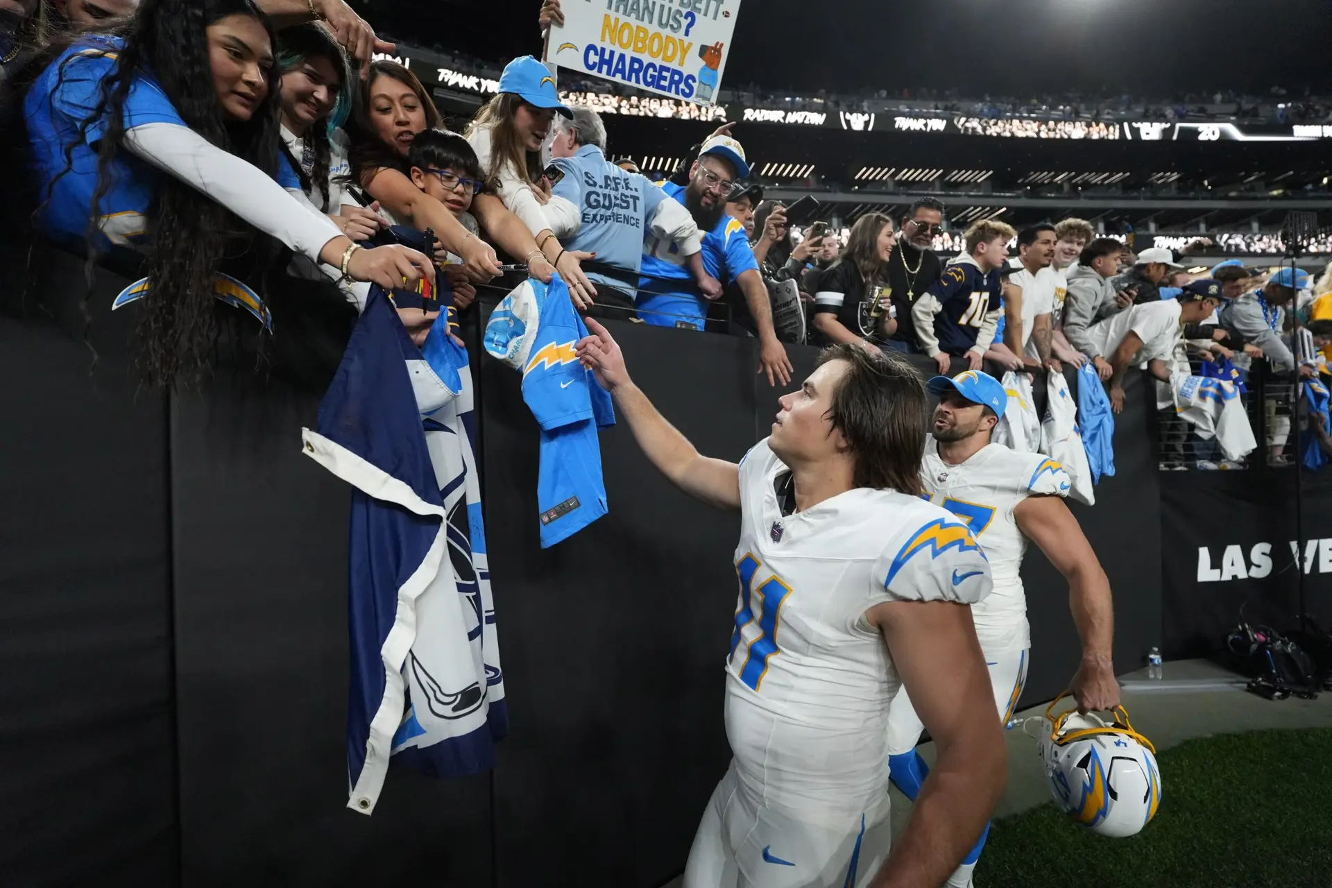 Jan 5, 2025; Paradise, Nevada, USA; Los Angeles Chargers place kicker Cameron Dicker (11) interacts with fans after the game against the Las Vegas Raiders at Allegiant Stadium. Mandatory Credit: Kirby Lee-Imagn Images