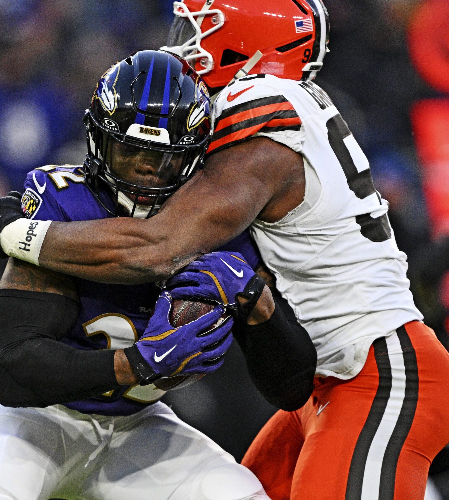 Jan 4, 2025; Baltimore, Maryland, USA; Baltimore Ravens quarterback Lamar Jackson (8) controls the ball as Cleveland Browns defensive end Myles Garrett (95) defends during the first quarter at M&T Bank Stadium. Mandatory Credit: Tommy Gilligan-Imagn Images