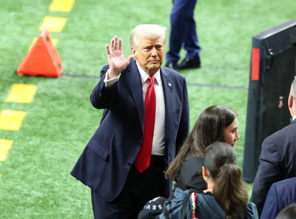 Feb 9, 2025; New Orleans, LA, USA; President Donald Trump leaves the field after participating in a meet and greet with the honorary coin toss participants including family members of the victims from the terrorist attack, members of the New Orleans Police Department, and emergency personnel before Super Bowl LIX between the Philadelphia Eagles and the Kansas City Chiefs at Ceasars Superdome. Mandatory Credit: Stephen Lew-Imagn Images