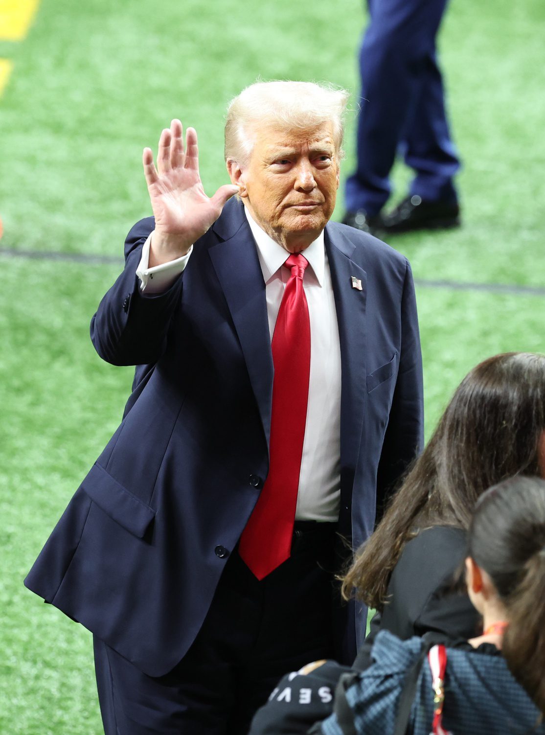 Feb 9, 2025; New Orleans, LA, USA;  President Donald Trump leaves the field after participating in a meet and greet with the honorary coin toss participants including family members of the victims from the terrorist attack, members of the New Orleans Police Department, and emergency personnel before Super Bowl LIX between the Philadelphia Eagles and the Kansas City Chiefs at Ceasars Superdome. Mandatory Credit: Stephen Lew-Imagn Images