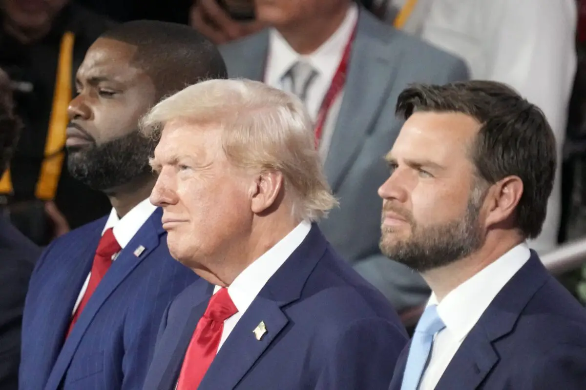 Jul 15, 2024; Milwaukee, WI, USA; Republican presidential nominee Donald J. Trump (center) is seen in the audience with Republican vice presidential nominee Sen. J.D. Vance, R-Ohio (right) and Rep. Byron Donalds, R-Fla. (right) during the first day of the Republican National Convention. The RNC kicked off the first day of the convention with the roll call vote of the states. Mandatory Credit: Jasper Colt-USA TODAY