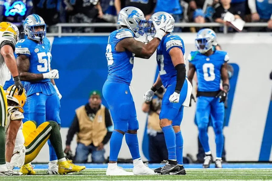 Detroit Lions linebacker Ezekiel Turner (47), right, celebrates a play against Green Bay Packers defensive end Za'Darius Smith (99) during the second half at Ford Field in Detroit on Thursday, Dec. 5, 2024. © Junfu Han / USA TODAY NETWORK via Imagn Images